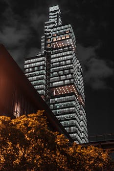 Captivating urban nightscape featuring a modern illuminated skyscraper.