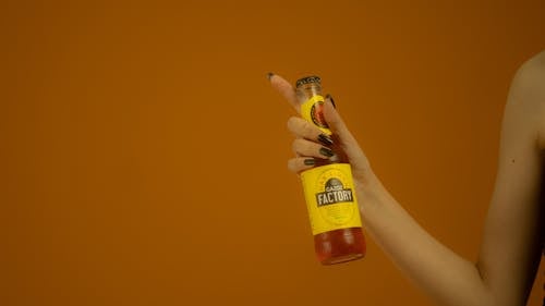 A Woman Holding a Bottled Drink