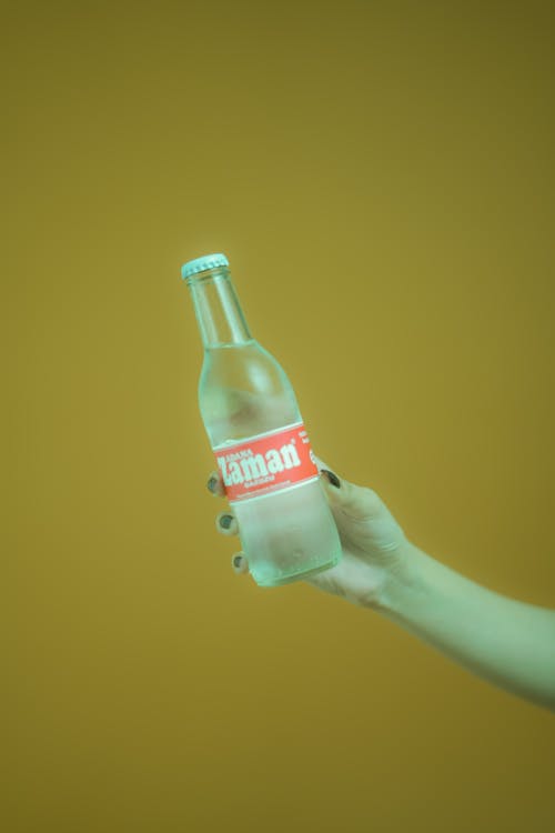 Hand Holding a Glass Bottle