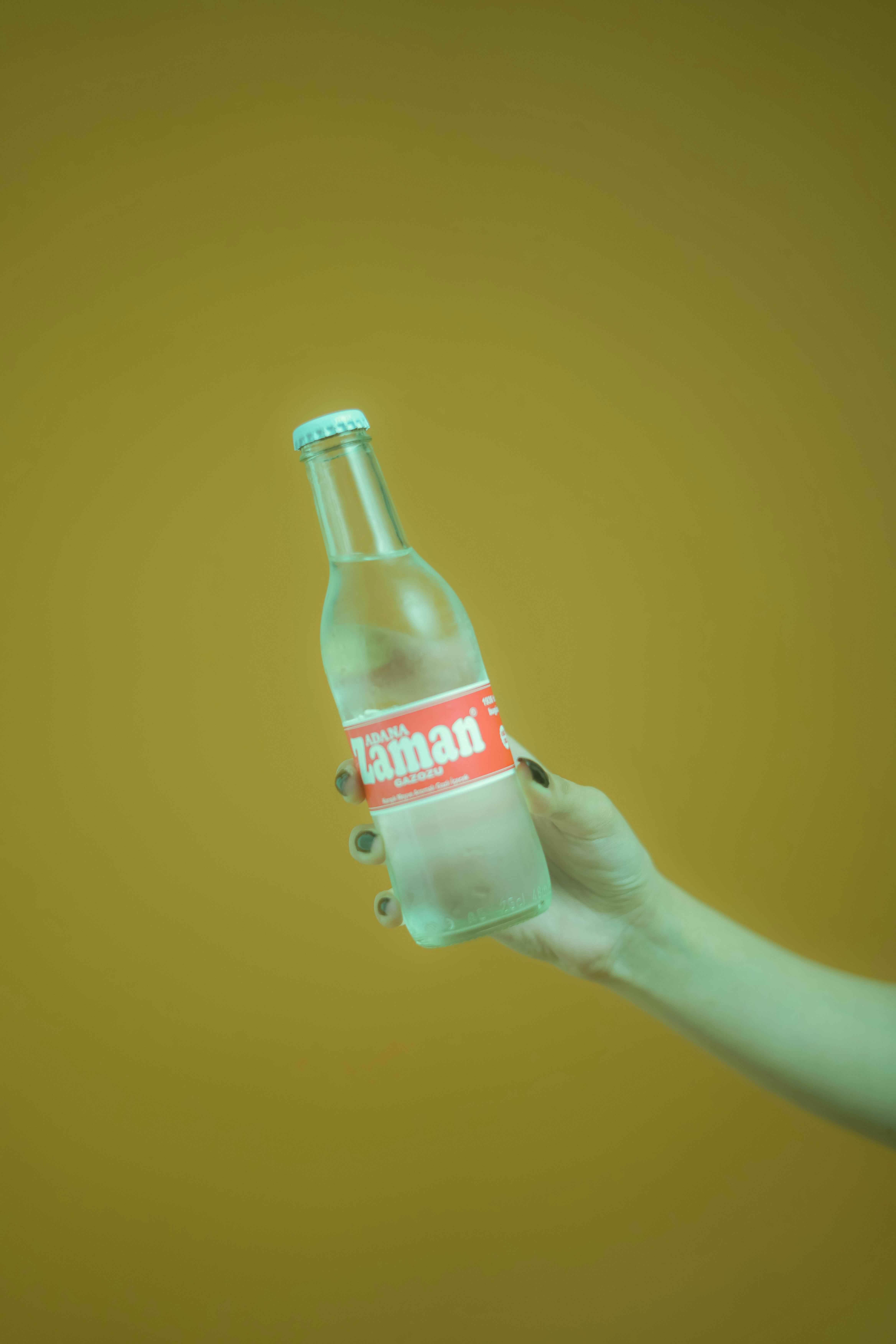 A Person Holding Clear Glass Bottle · Free Stock Photo