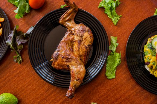 Roasted Chicken Served on Black Ceramic Plate