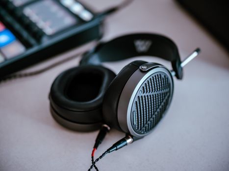 Close-up of high-end headphones on a desk, showcasing sleek design and premium build.