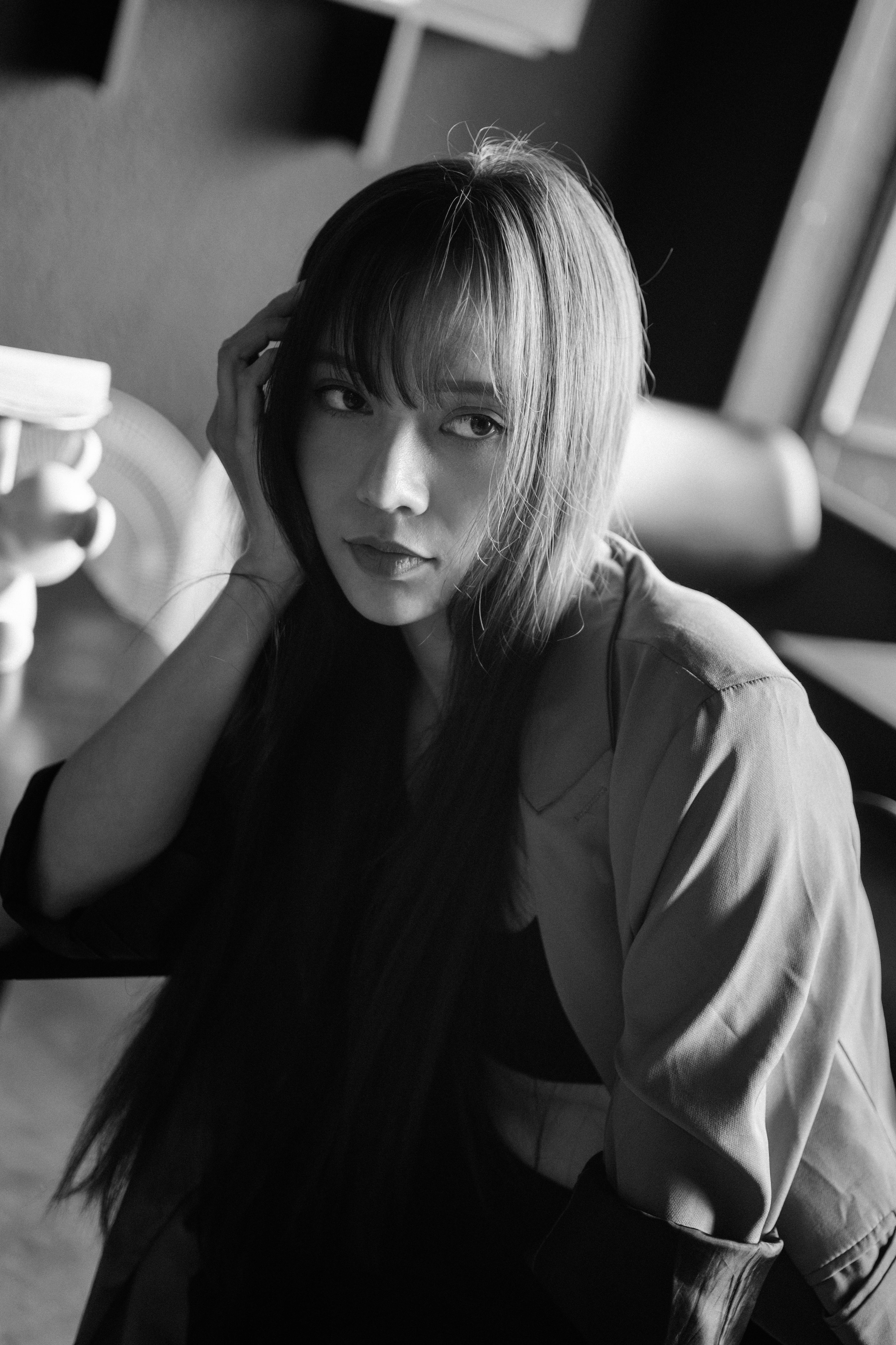 Black and white portrait of a woman with long hair and thoughtful expression.