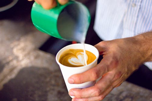 Person Pouring Cream 