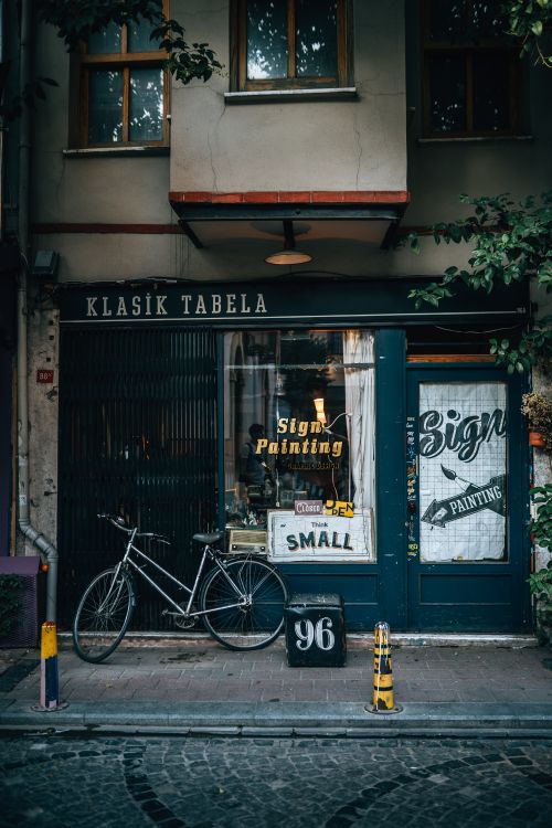 Free Charming İstanbul storefront with a vintage bicycle, showcasing a classic sign painting shop. Stock Photo