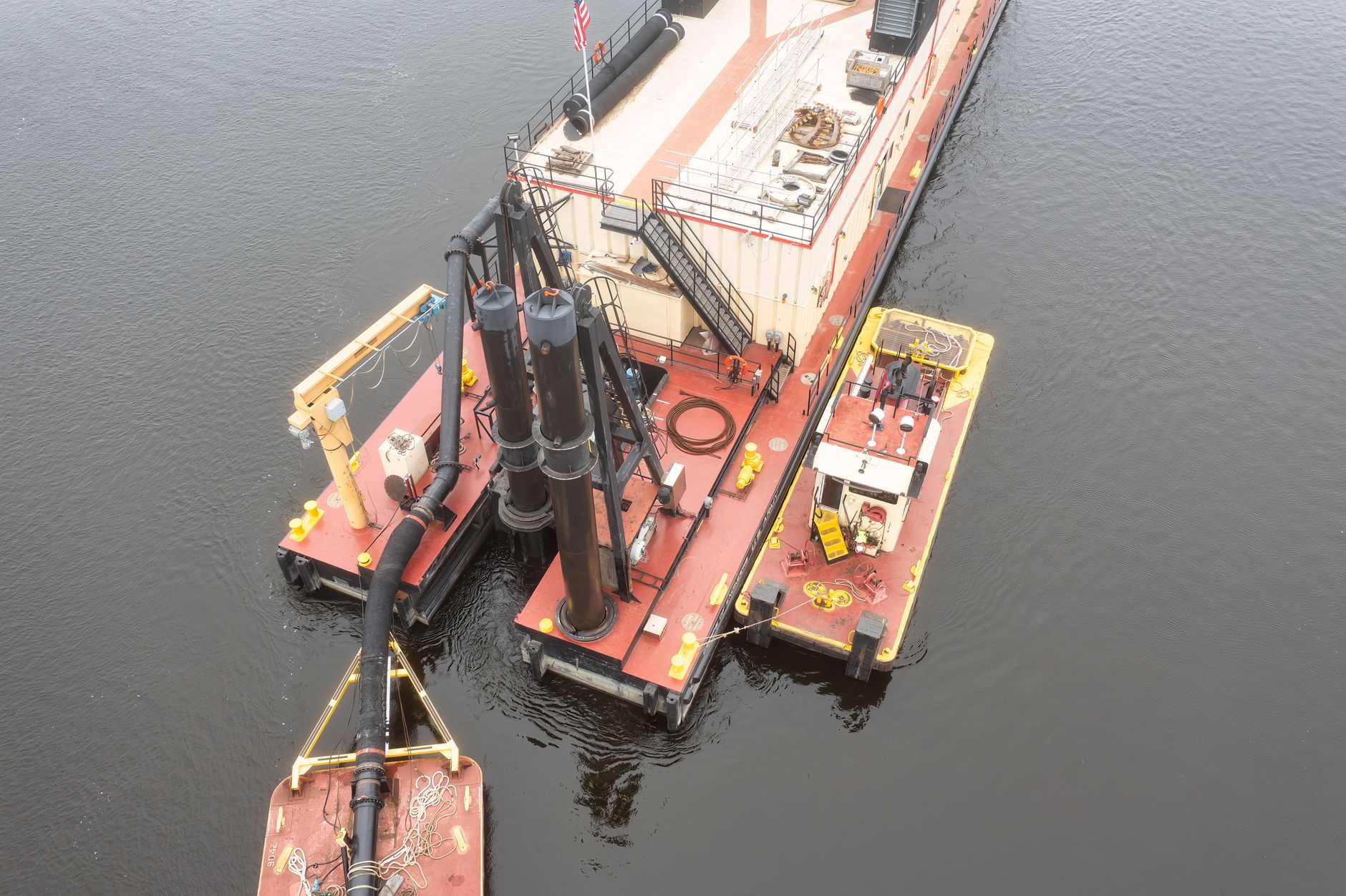 Aerial view of a barge and platform on water in Trevino, WI, showcasing industrial operations.