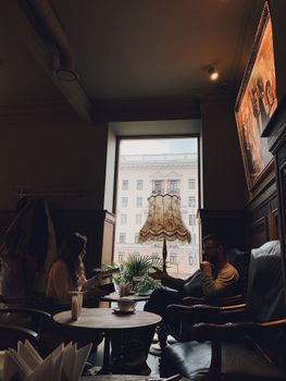 Two people enjoy a warm conversation in a stylish Minsk coffee shop.