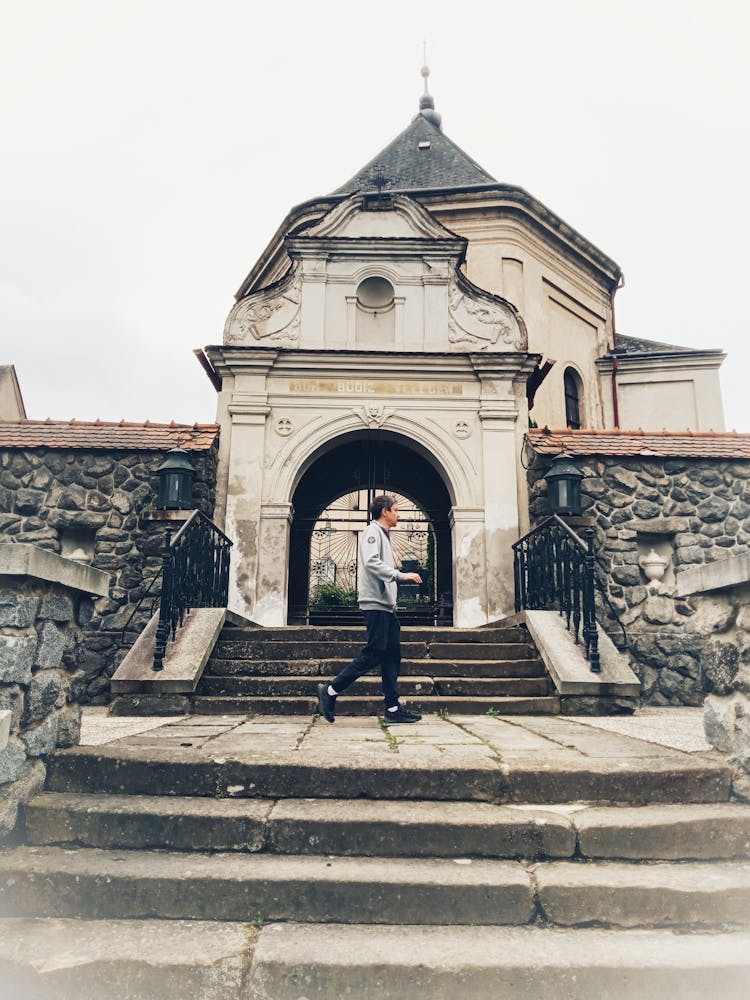 Man Walking At The Entrance Of A Building