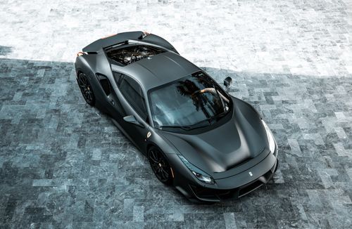 Free Sleek black sports car parked on a paved urban area viewed from above. Stock Photo