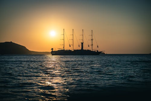 Silhouette of a Ship on Sea During Sunset