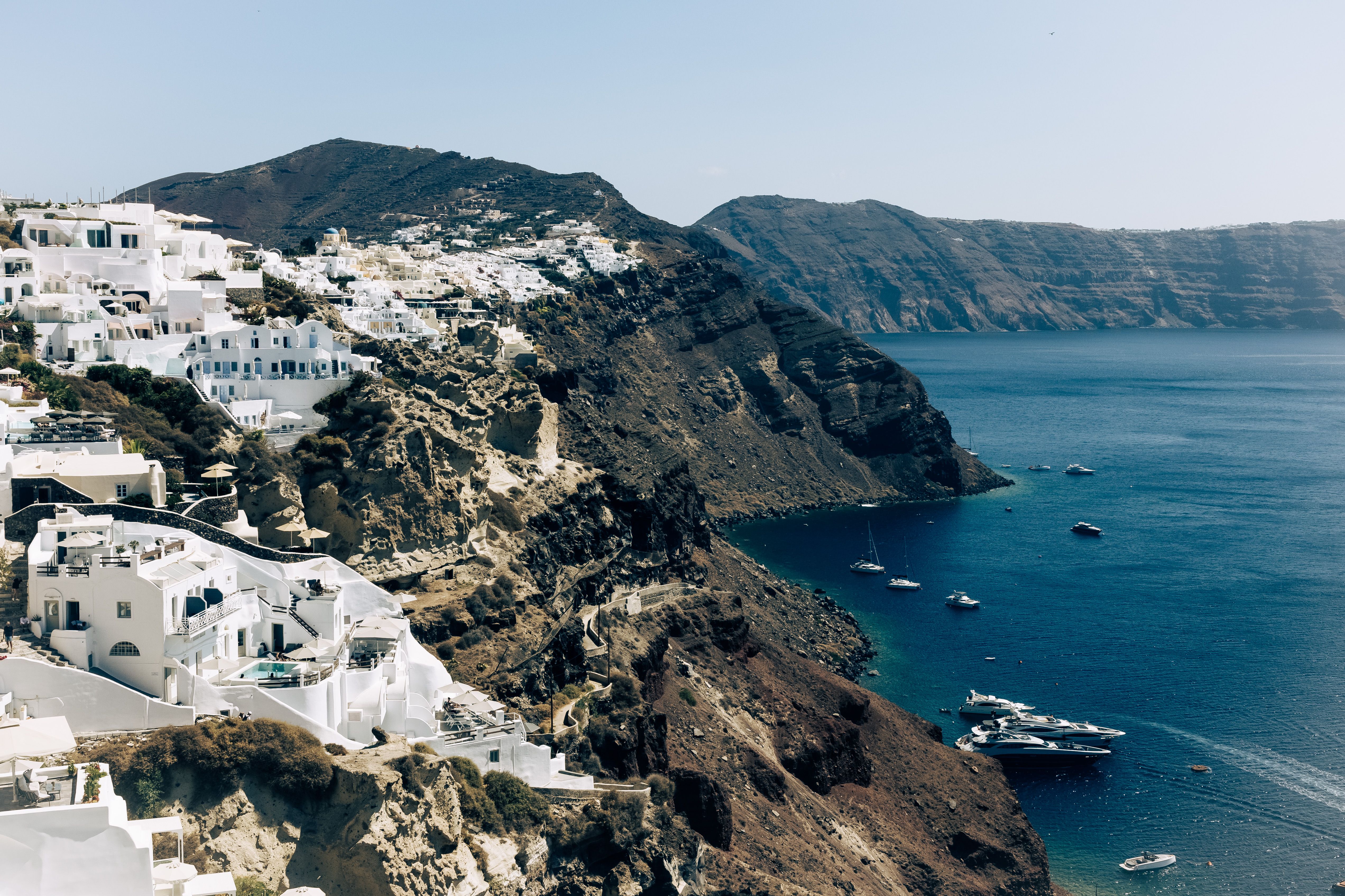 Breathtaking aerial view of Santorini's iconic white houses on cliffs overlooking the Aegean Sea.