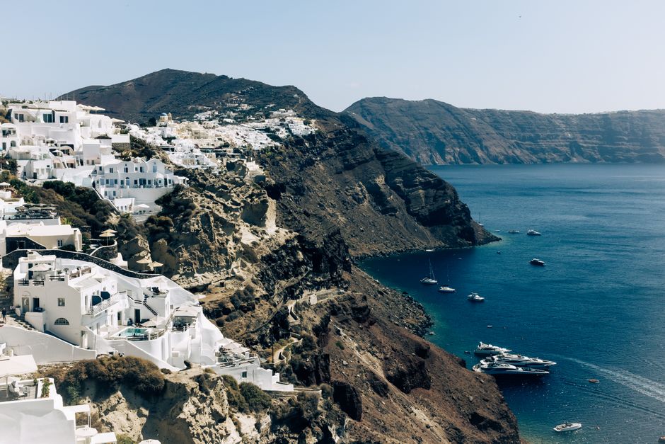 Breathtaking aerial view of Santorini's iconic white houses on cliffs overlooking the Aegean Sea.