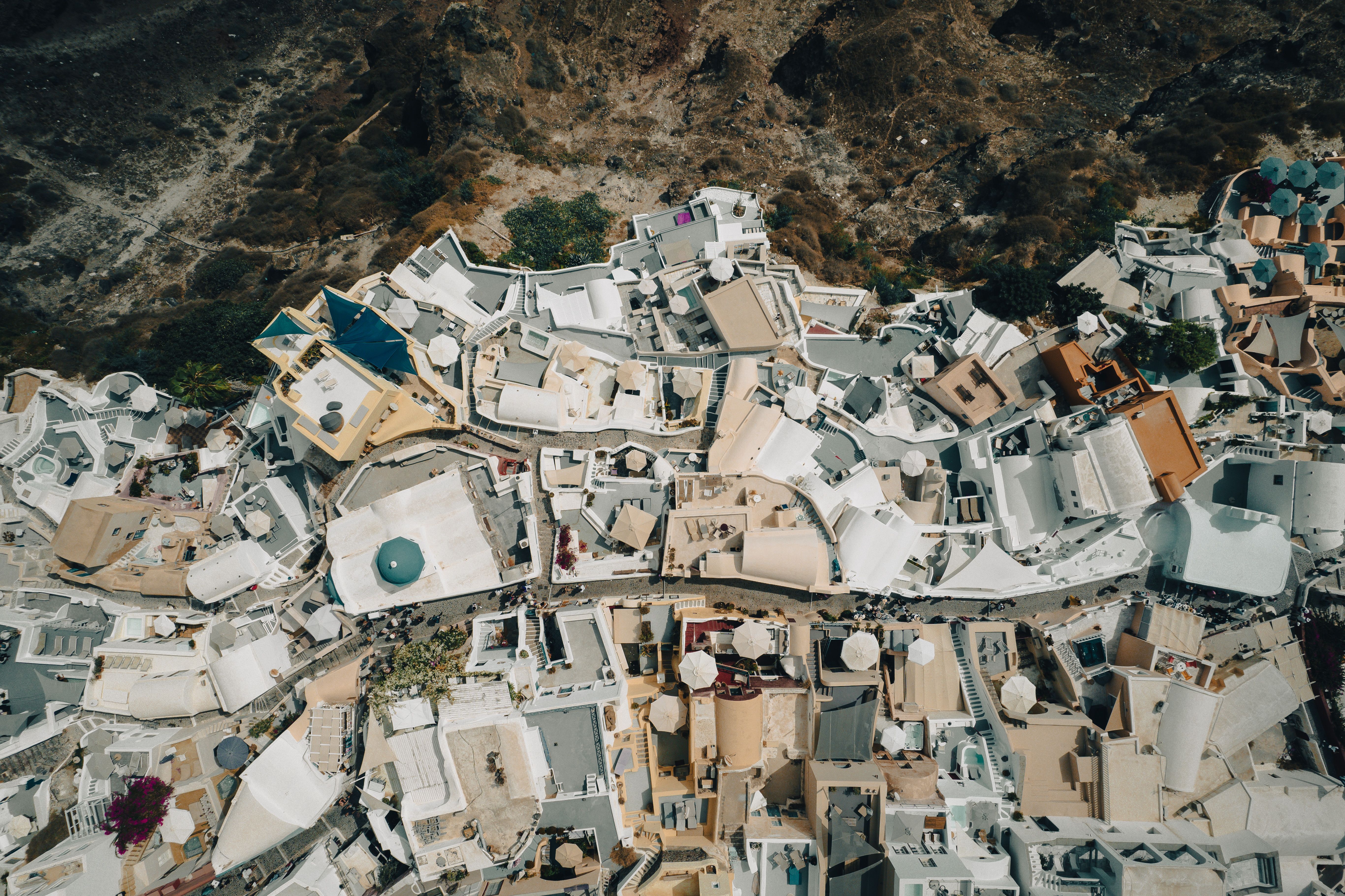Spectacular Private Helicopter Transfer from Santorini to Mykonos Review: The Ultimate Greek Island-Hopping Experience Review 2026 - Stunning aerial perspective of Santorini's unique whitewashed buildings overlooking rocky landscapes.