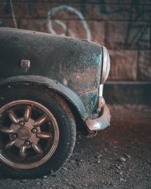 Free Close-up of a dusty vintage car wheel in an urban setting in London. Stock Photo