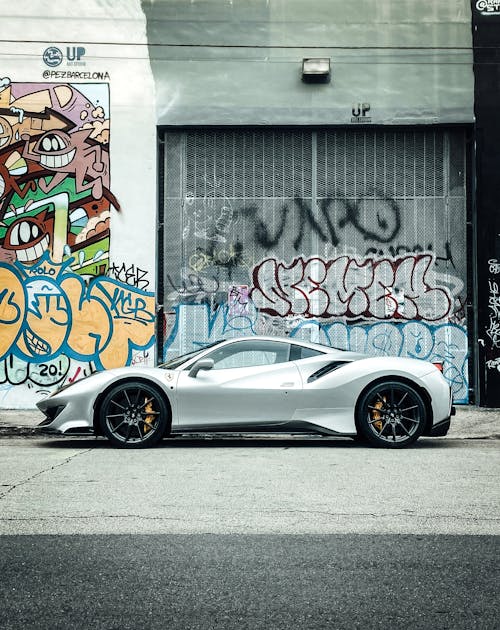 Luxury Car Parked near Graffiti Wall