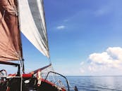 蔚蓝的天空下，一艘帆船在平静的海洋中航行，非常适合休闲航行