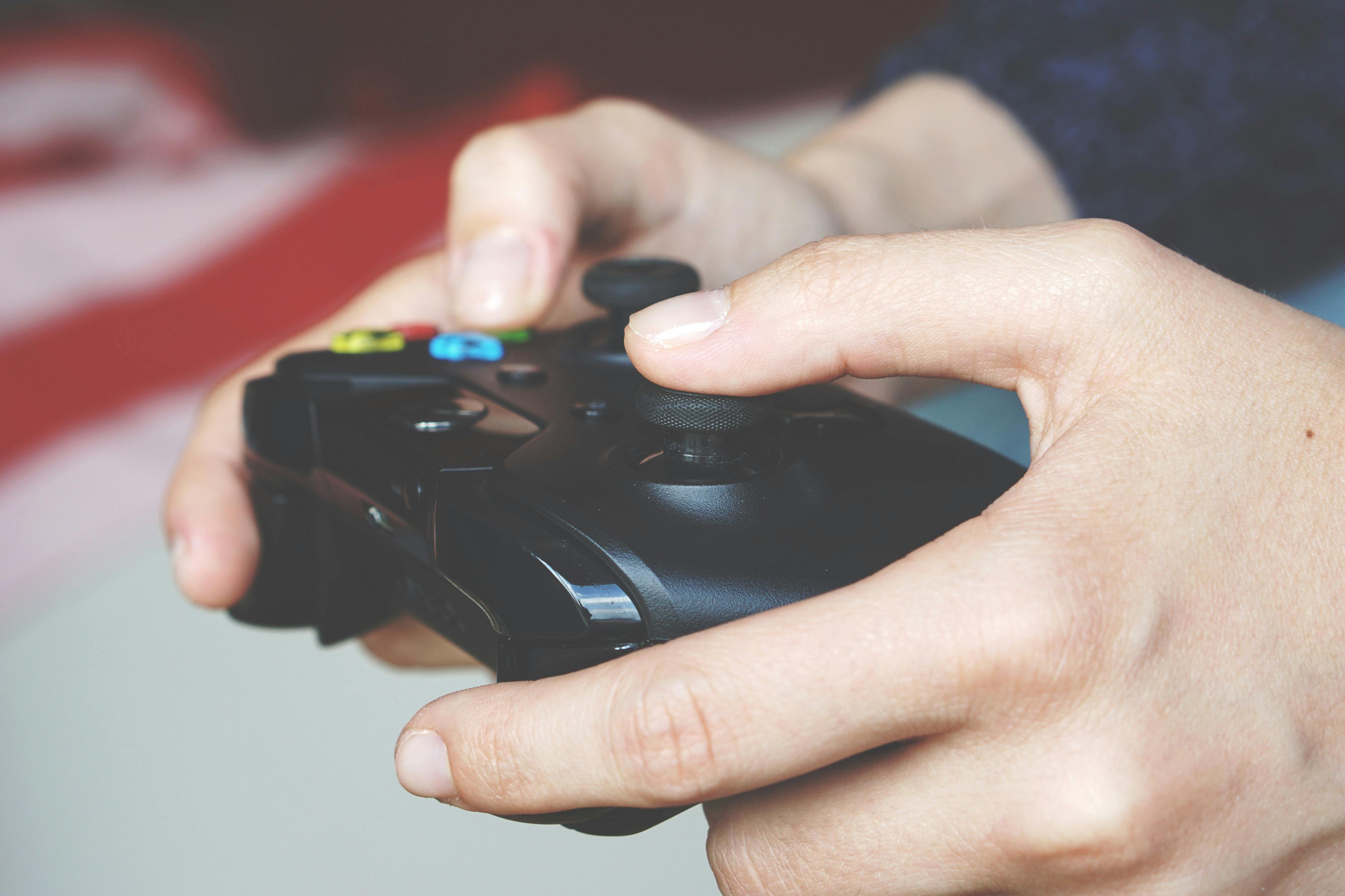 Man Holding Black Game Controller · Free Stock Photo