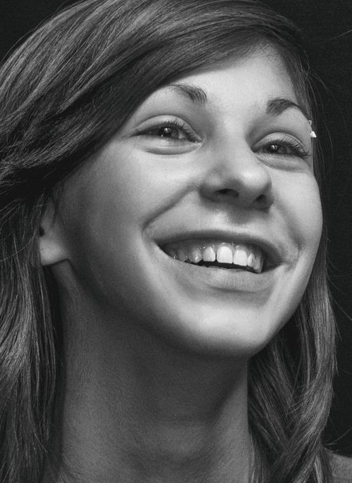 Free A close-up black and white portrait of a woman smiling joyfully. Stock Photo