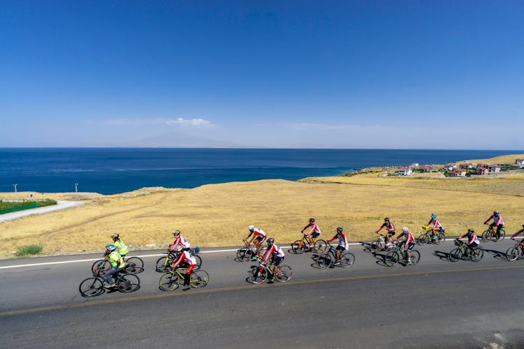 People Riding Bicycles On The Road