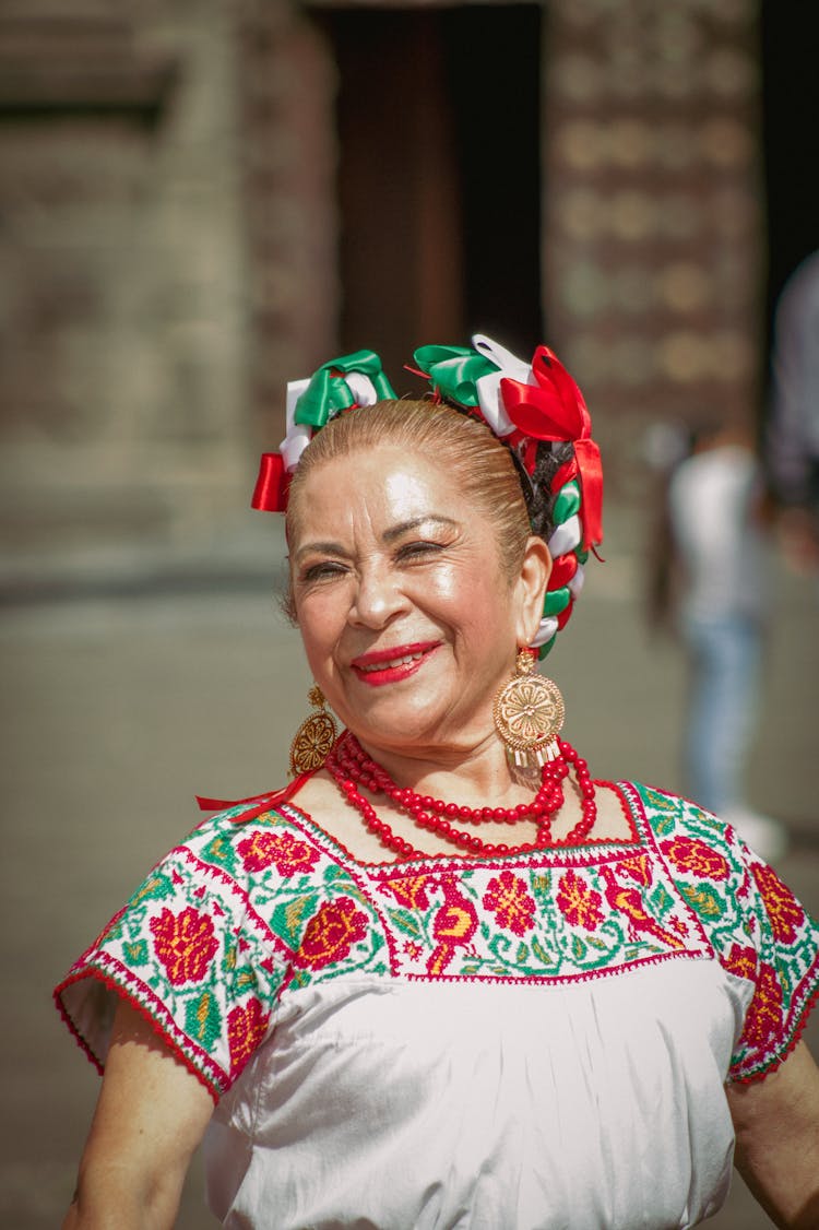 Portrait Of Smiling Old Woman In Traditional Clothes