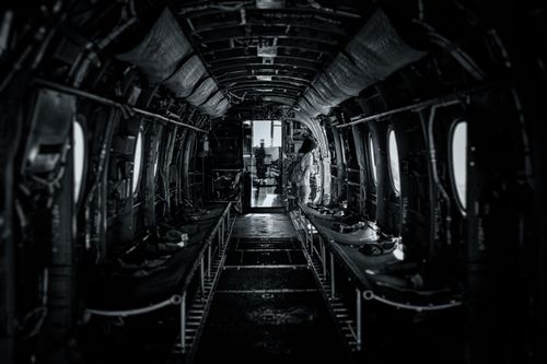 Free Black and white interior view of a military aircraft with one person onboard in San Diego. Stock Photo