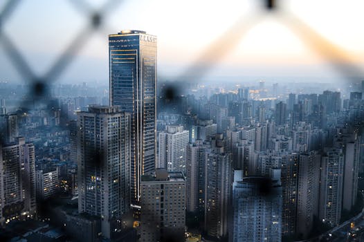 Aerial view of a cityscape with skyscrapers at twilight, showcasing modern architecture.