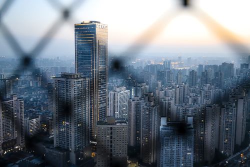 Free Aerial view of a cityscape with skyscrapers at twilight, showcasing modern architecture. Stock Photo