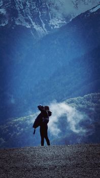 Captivating scene of a photographer capturing the misty mountains of Estosadok, Russia.