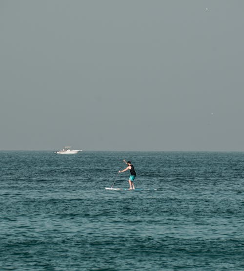 Free A Person Paddleboarding at Sea Stock Photo