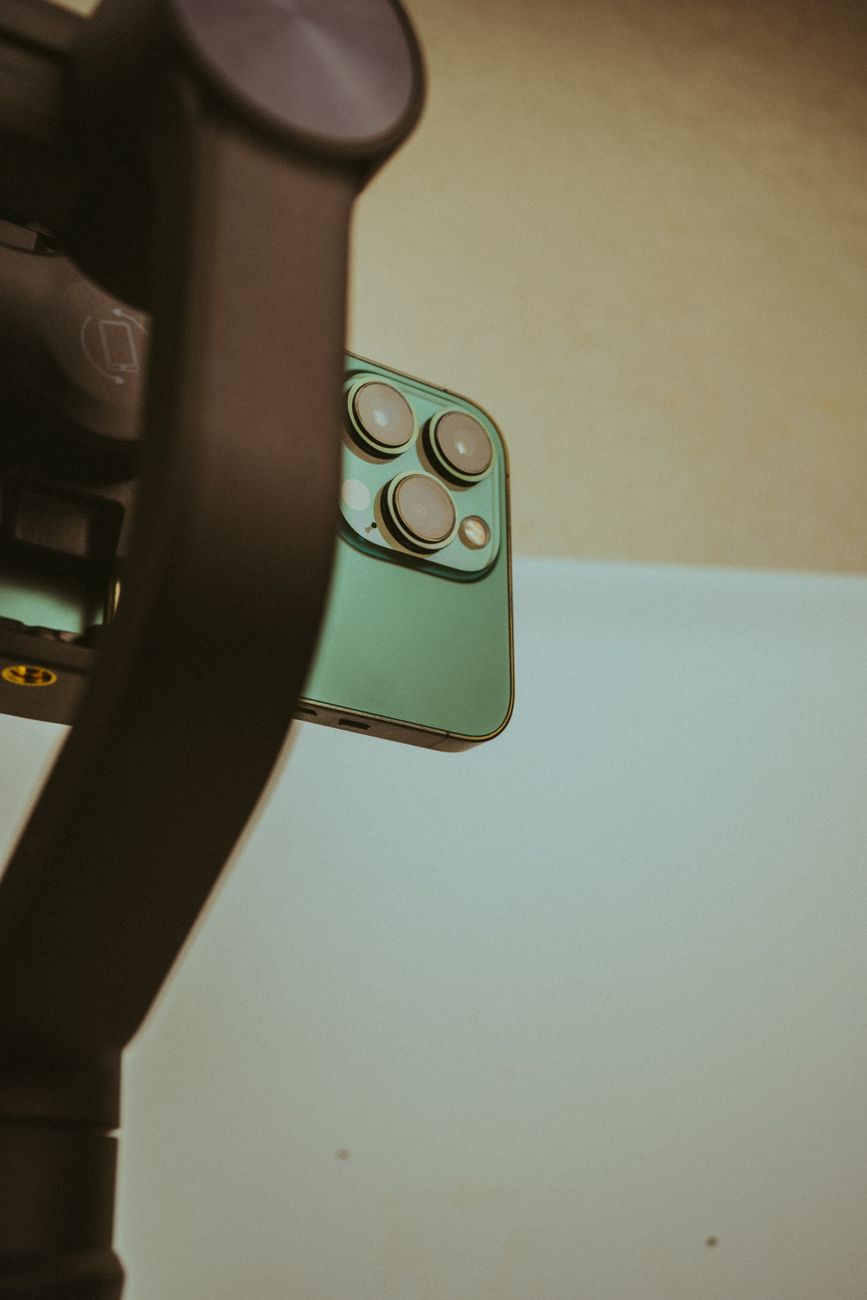 Minimalist close-up of a smartphone mounted on a gimbal, perfect for tech enthusiasts.