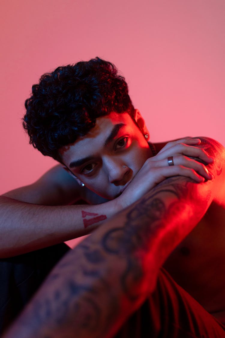 Young Man With Tattoos Posing In Studio 