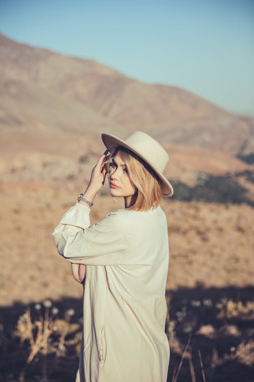 Beautiful Woman Wearing a Hat and a White Dress