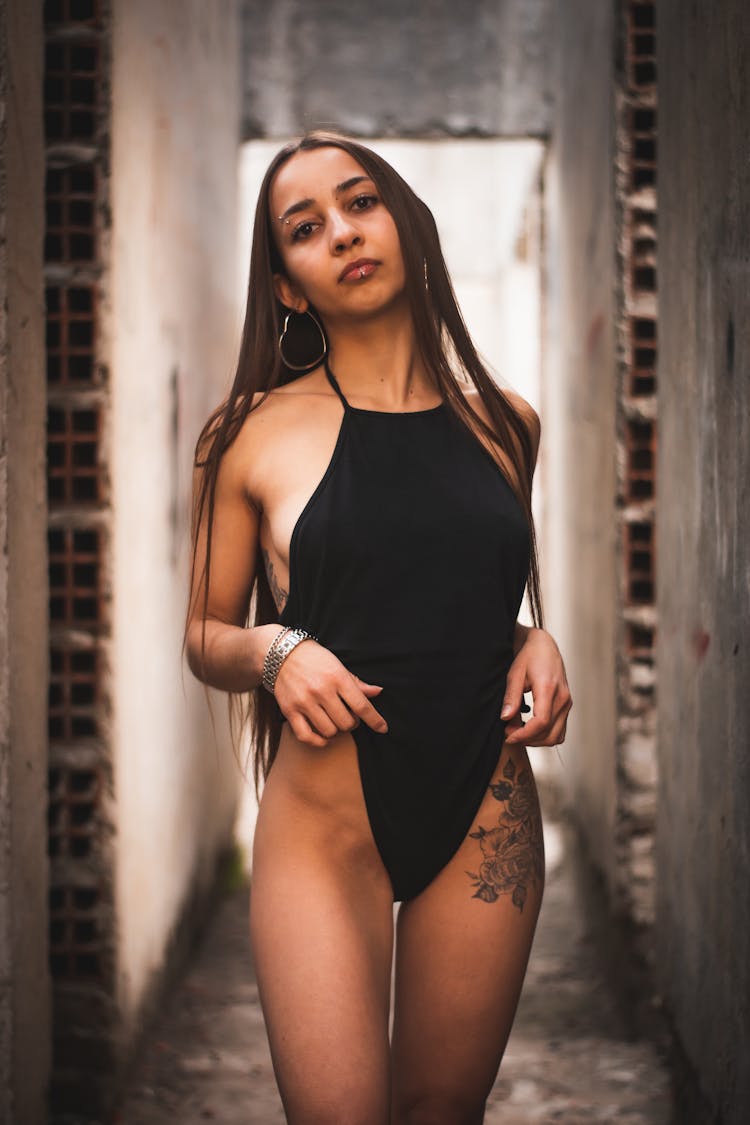 Woman With Tattoo Posing In Bodysuit