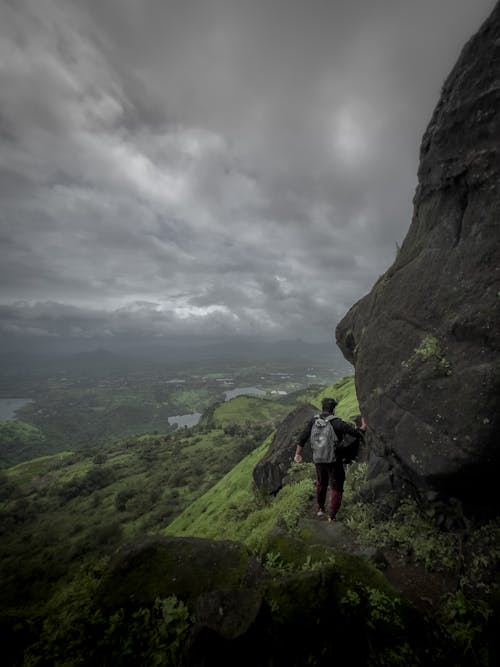 A Boy Hiking On The Edge Of Cliff