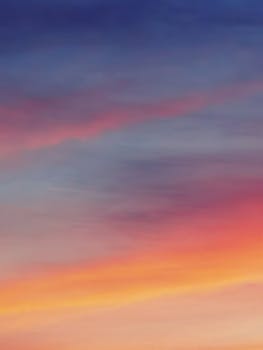 Capture the beauty of a vibrant sunset with multi-layered colorful clouds creating a breathtaking sky.