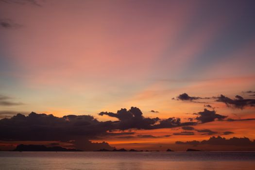 Beautiful sunset over the ocean with vibrant colors and dramatic clouds.