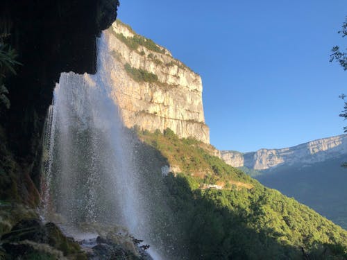 Free Waterfalls on Rocky Mountain Under Blue Sky Stock Photo