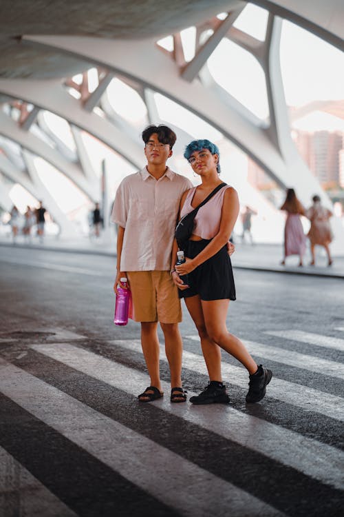 Man and Woman Standing on Crossroad 