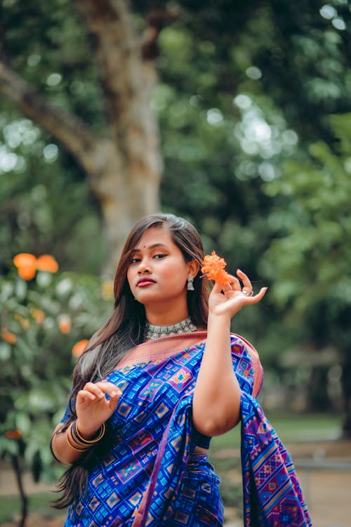 Beautiful Woman Holding an Orange Flower