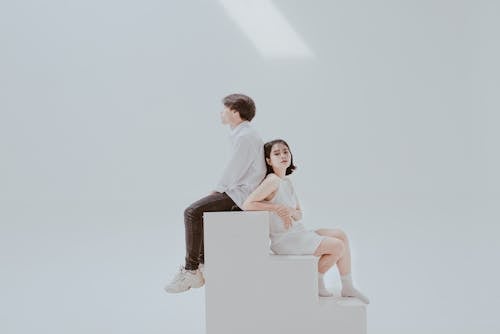 Free Photo of Woman Sitting on Staircase Beside Man Stock Photo