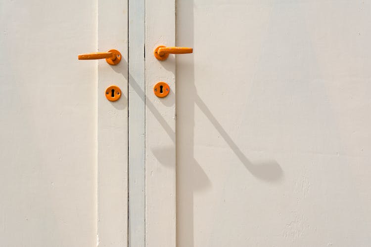 White Door With Wooden Handles And Key Holes