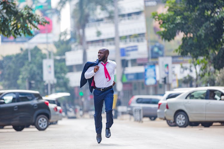 A Man In A Suit Running In The Street