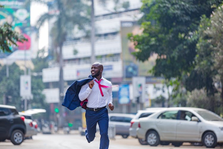 A Man In A Suit Running In The Street