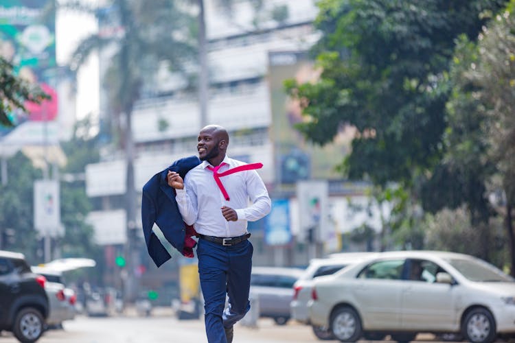 A Man In A Suit Running In The Street