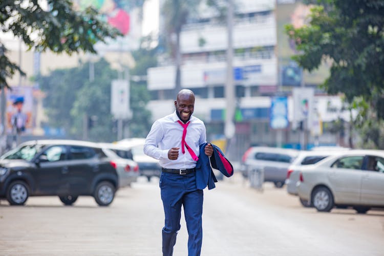 A Man In A Suit Running In The Street