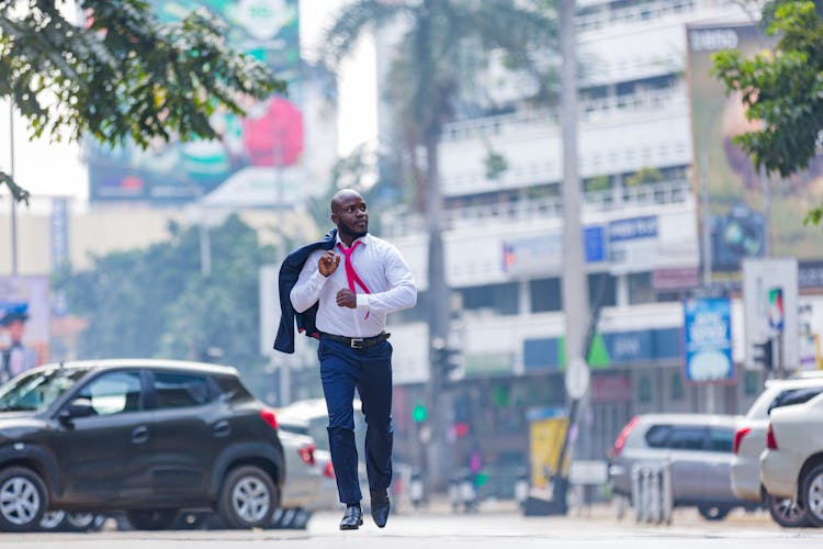 A Man In A Suit Running In The Street