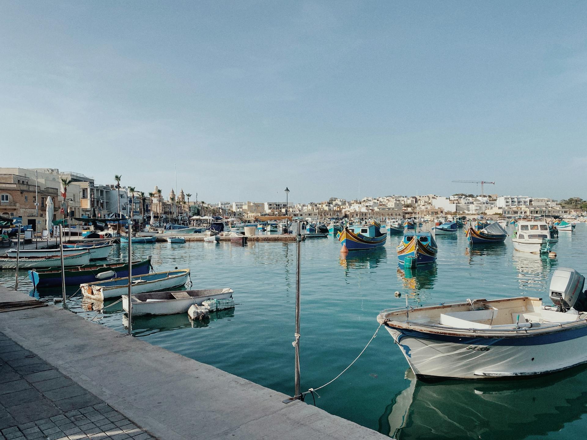 Beautiful view of colorful traditional boats in Marsaxlokk Harbour, Malta.