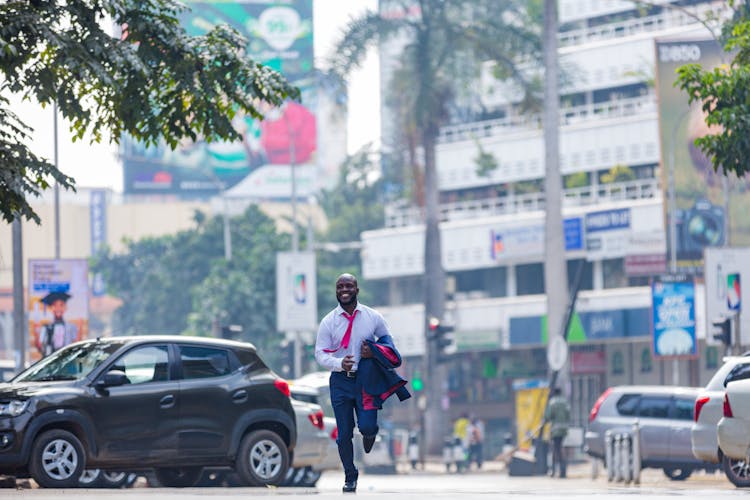 A Man In A Suit Running In The Street