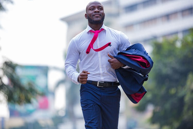 Man Wearing Suit Running In City