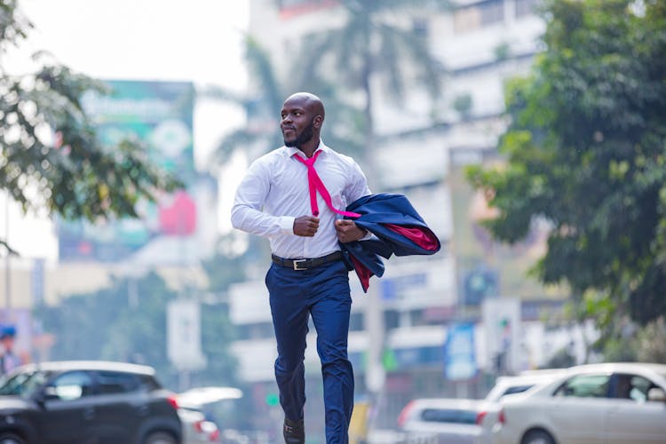 Elegant Man Running Holding Blazer